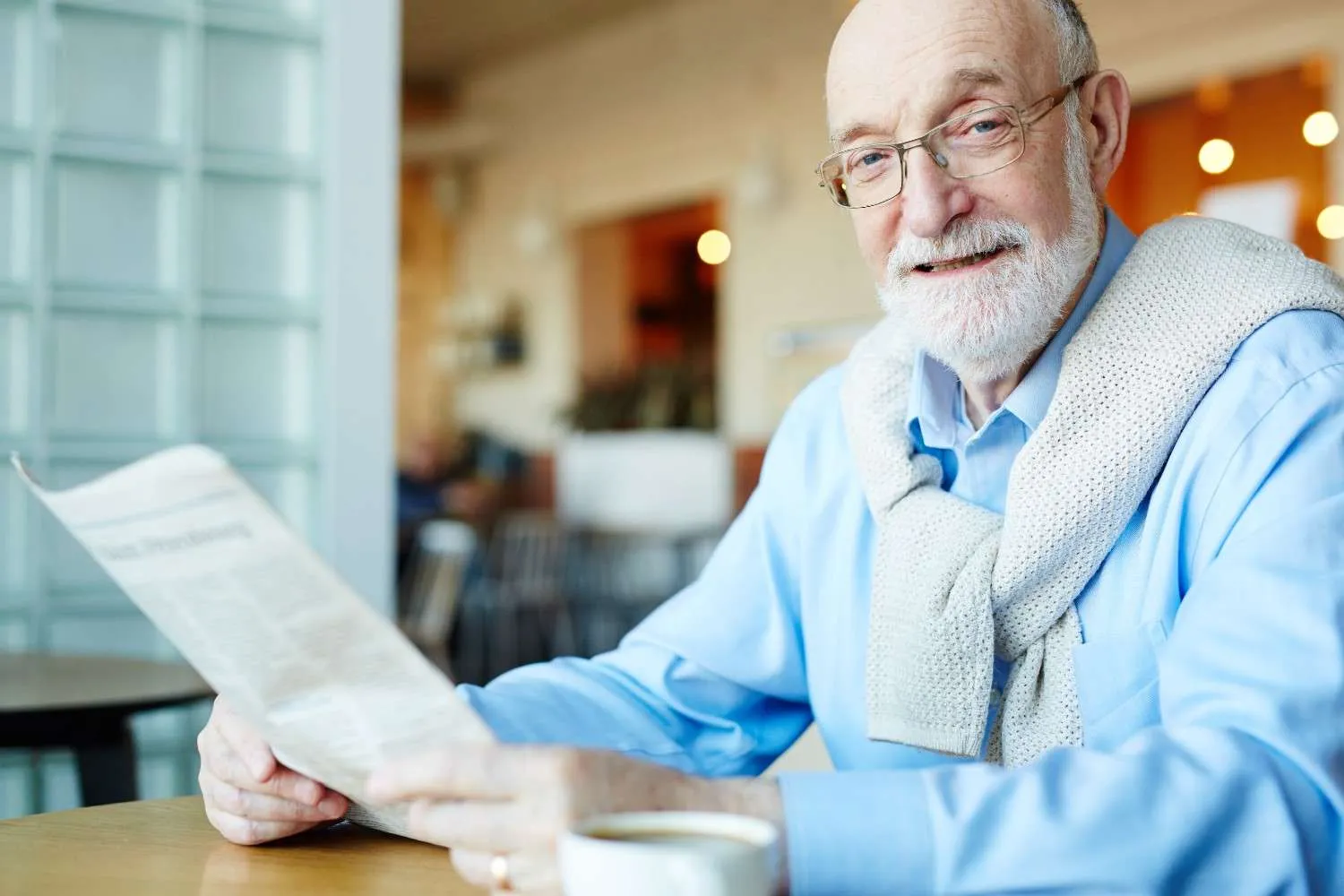 An older couple reading through paperwork together at a kitchen table