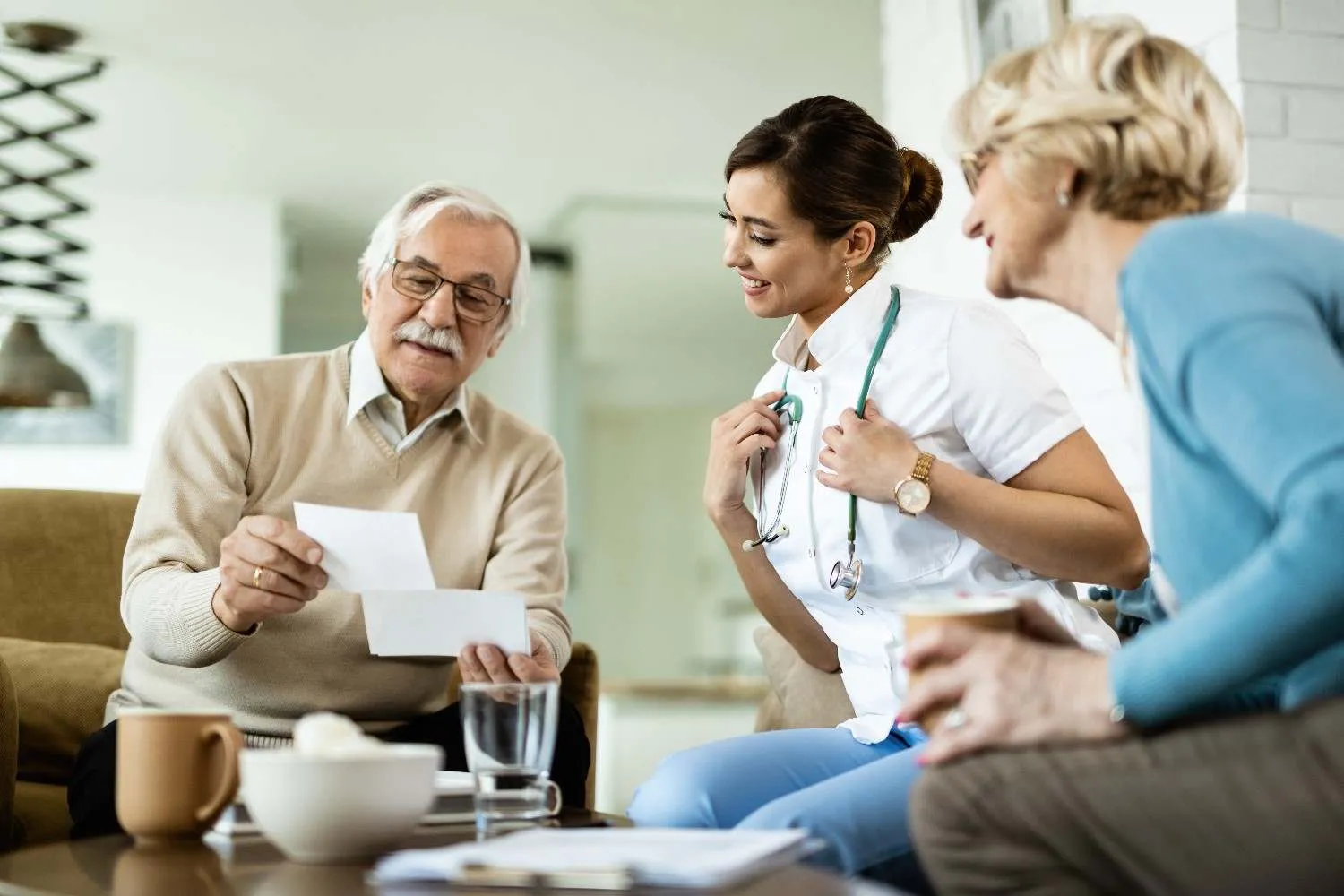 A nurse going over paperwork at home with an older couple